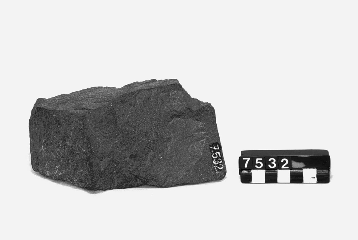 Prov på järnmalm, svartmalm från Hofors AB:s gruvor. vikt: 2,2kg, höjd: 75 mm, längd: 135 mm, bredd: 80 mm. Finkornig, använd för framställning av tackjärn TM7535.