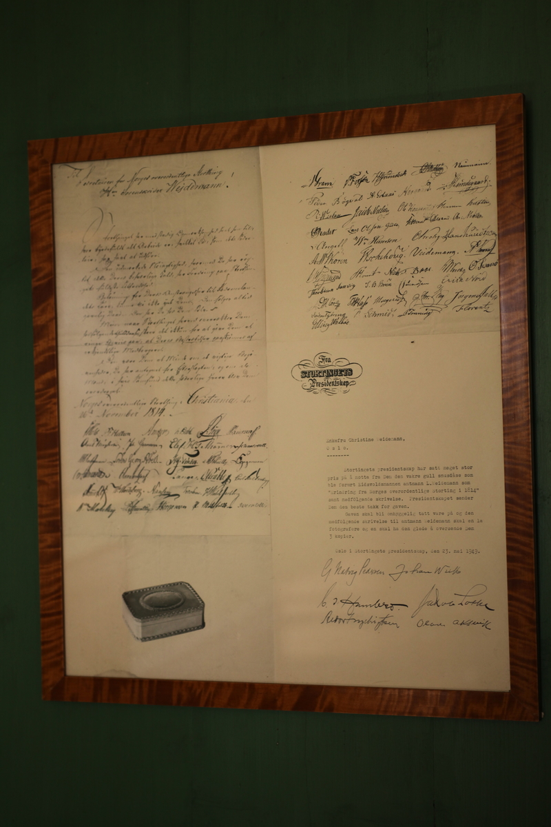 Innrammet fotografi av den takkeadresse (brev) som sorenskriver Weidemann fikk av Stortinget høsten 1814, bilde av snusdåsen han fikk og kopi av brev fra Stortinget 1949 i forbindelse med at snusdåsen ble gitt tilbake til Stortinget
