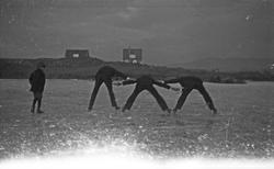Gruppebilde. Tre menn som leker seg på havisen. En gutt ser 
