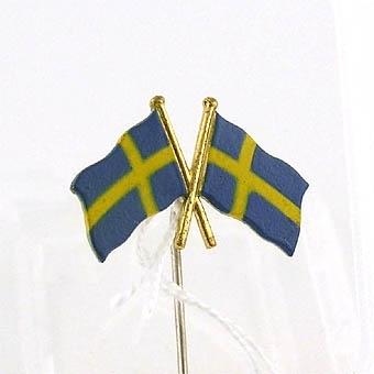 Märke i form av två korslagda svenska flaggor.

Enligt liggaren: Förenings- och idrottsmärken, 25 st. uppsatta på en tygremsa.