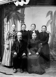 Familiebilde. Mor og far med voksne barn. Fire døtre. Foreld