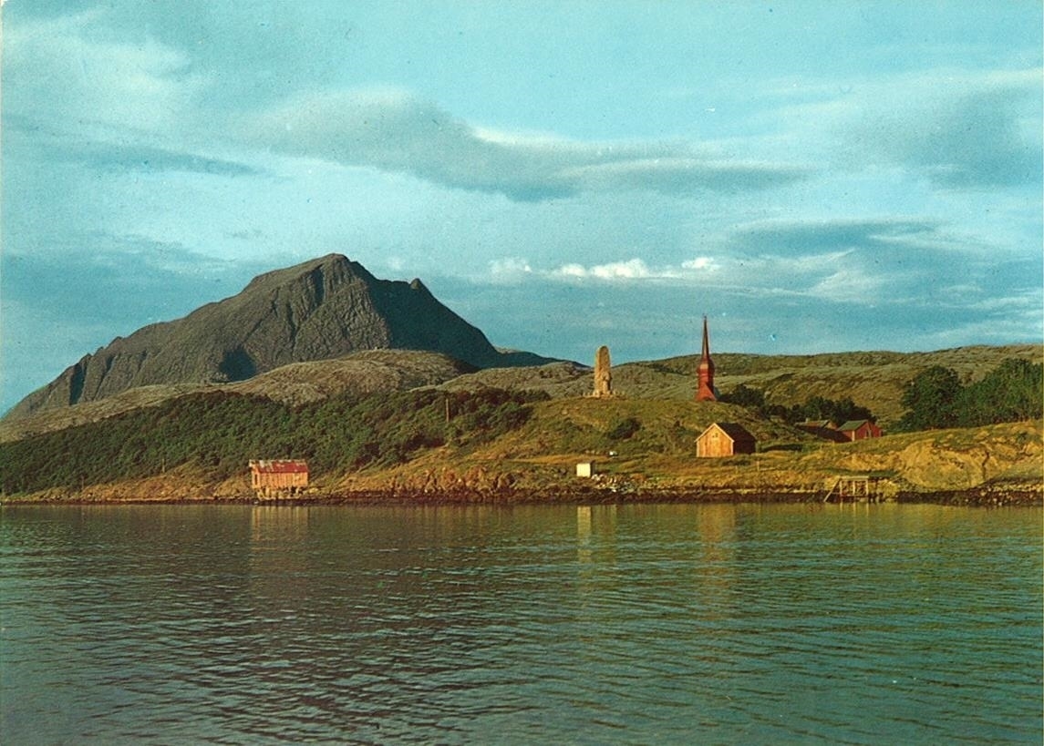Alstahaug med kirke, stabbur, del av eldhus, kjellerbu og brygge, sett fra sjøen. 
