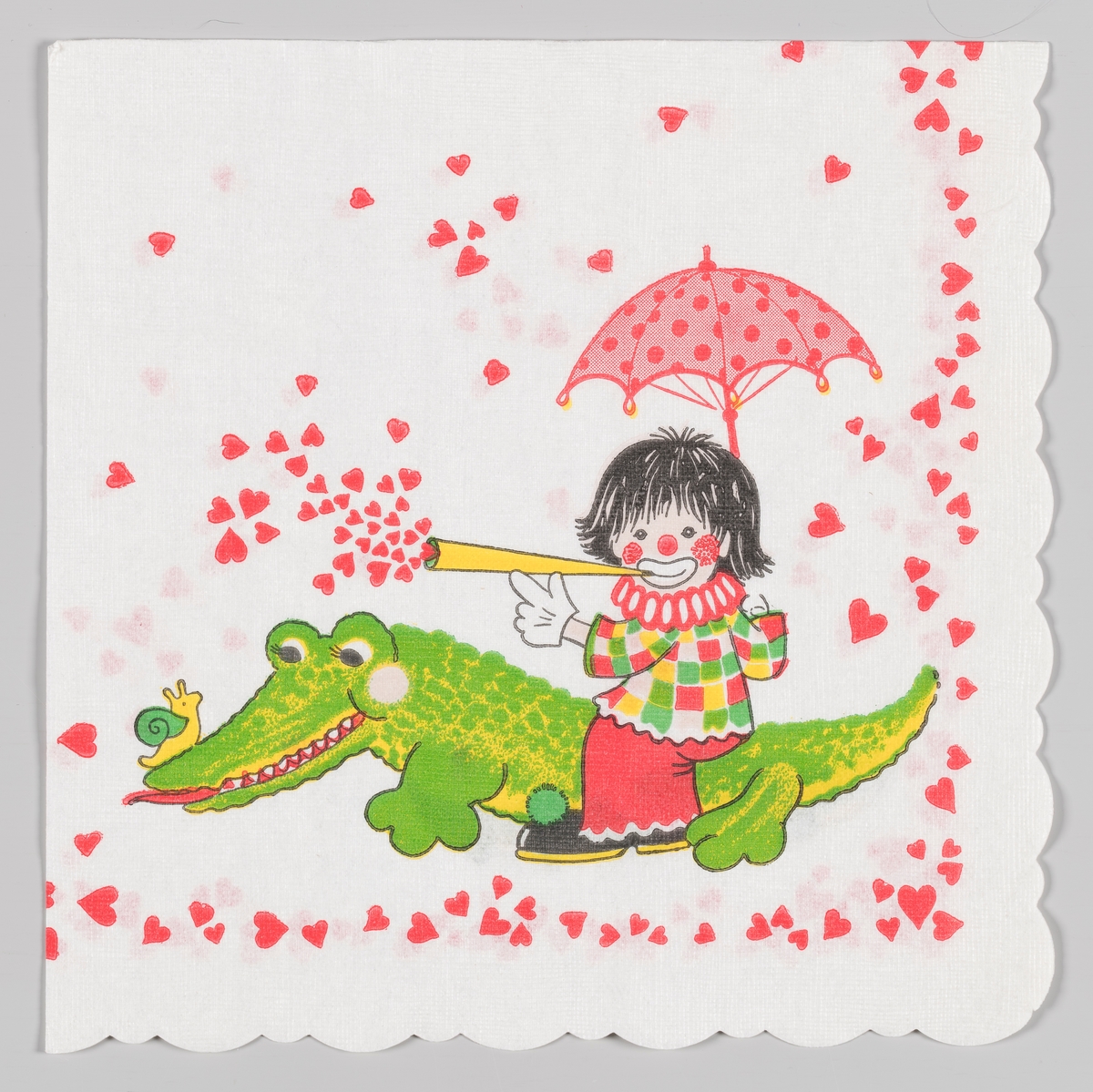 En klovn som sitter med paraply og blåser hjerter ut av et tutehorn. Klovnen sitter på en krokodille som har en snegle på snuten. Langs kanten er det masse hjerter.
