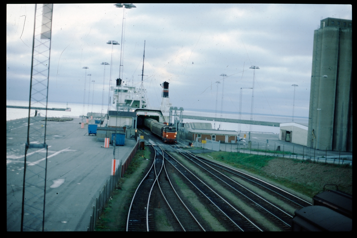 Bilden visar ett SJ V5 lok som dra av godsvagnar från den danska DanLink färjan Trekroner vid Helsingborgs Västhamn.
Godstrafiken över Sundet gick denna väg mellan 1987 och 2000.