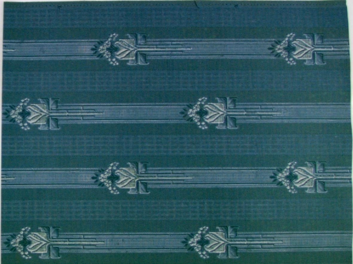 Randmönster med stiliserad tulpan i diagonalupprepning. Tryck i vitt och grönt på ett gråblått genomfärgat papper.