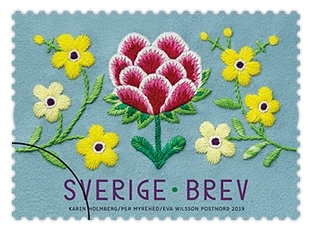 Tio självhäftande frimärken i rulle med motiv av en textil blomsterbård. Valör Brev.