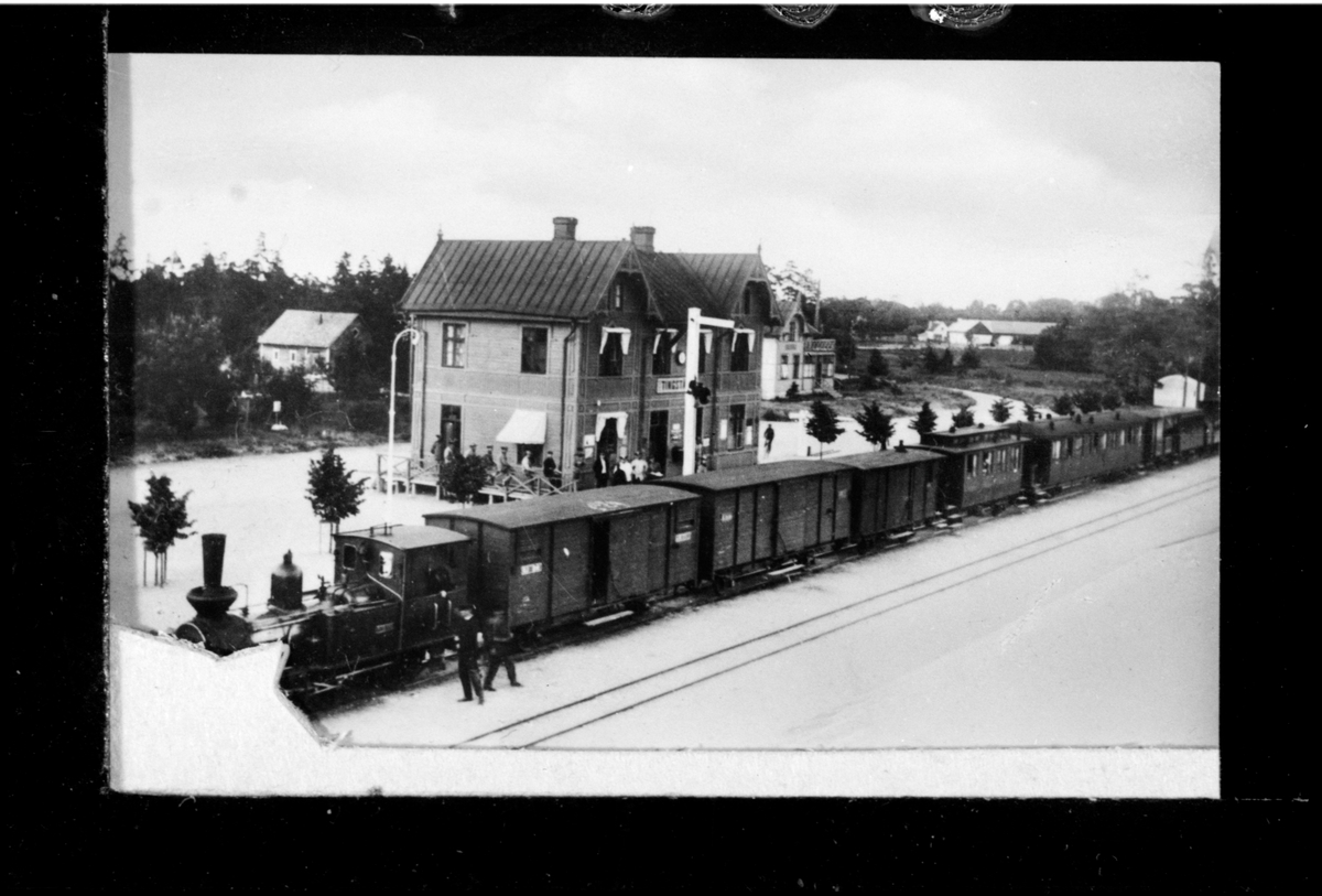 Tingstäde station med ångtåg och personal utanför stationshuset. Loket är förmodligen Gotlands Järnvägar, GJ lok 1 "Wisby".