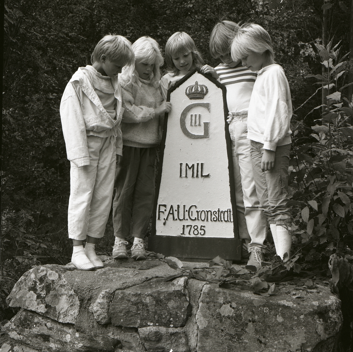 Skolungdomar från Kyrkskolan poserar intill en milsten vid 200-årsfirandet av milstolparna, 3 september 1985.