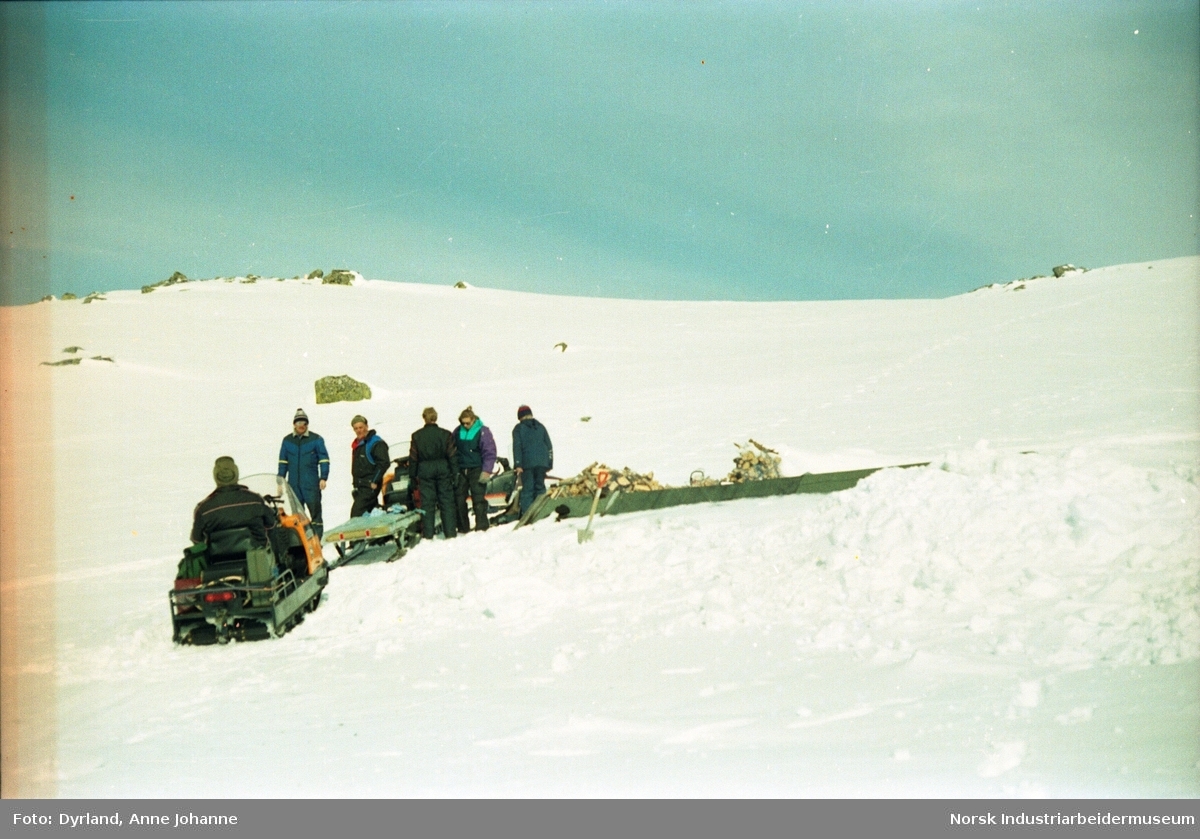 Vedkjøring med snøskuter og slede til hytta Olavsbu i Kvamsfjellet. Taket på hytta synes i snøen.