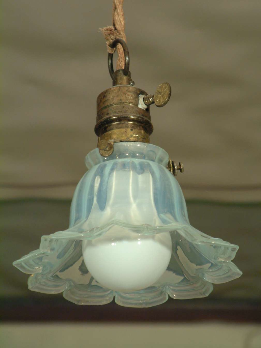 Liten taklampe med klokkeformet glasskjerm. Skjermen er gjennomsiktig melkehvit med blåskjer.