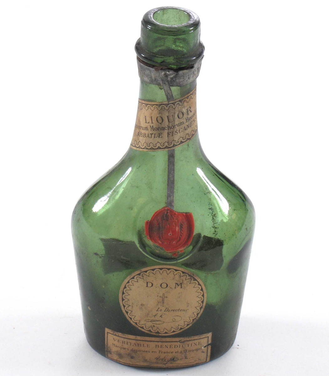 Flaske med oval bunn, lav "kropp" og lang hals. Rest av forseglingsstempel av lakk.