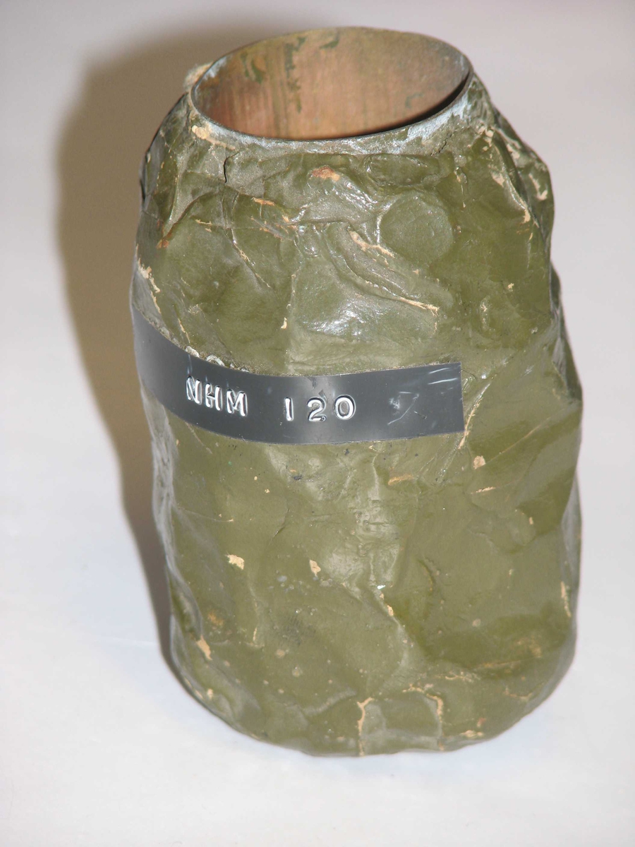 Sylinderformet rør med grønn tape viklet rundt metallfragmenter. Rom for sprengladning i rør. (fjernet)
Høyde: 85 mm
Diameter: 53 mm